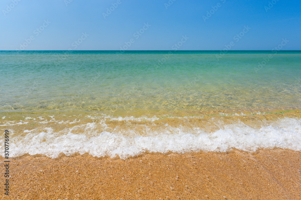 Sandy beach and clean transparent sea. Travel seascape.