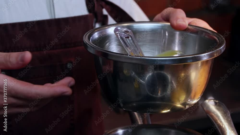 Restaurant kitchen - the chef mixing ingredients in the bowl Restaurant kitchen - the chef mixing ingredients in the bowl