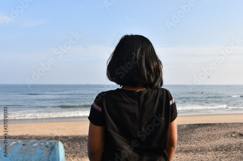 A little girl looking at the sea