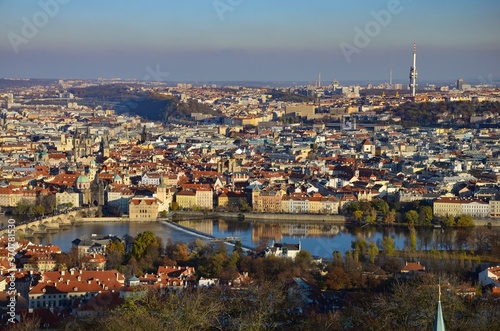 Prague city with Charles Bridge, aerial view towards river Moldau, sunny day in autumn