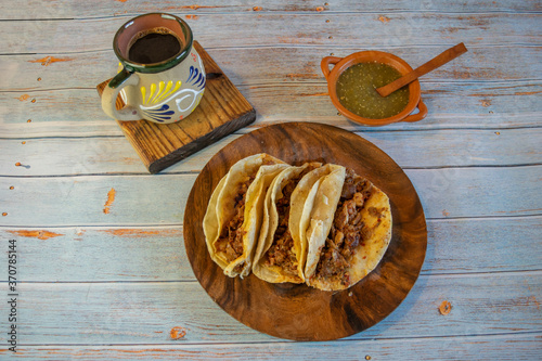 Mexican tacos with barbecue, green sauce and cafe de la olla photo