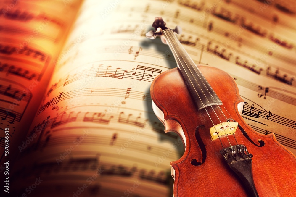 Fototapeta premium Classic sheets with music notes sign and a violin