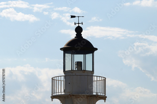 weather vane on the roof of the observation tower against a cloudy sky