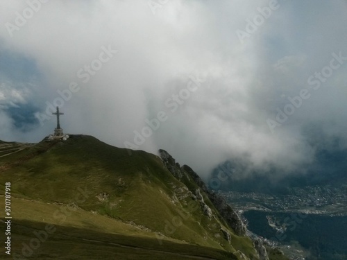 the cross of the heroes on top of the mountain above the clouds