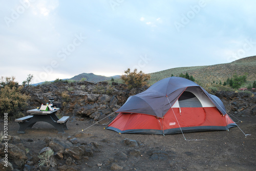 A campsite with large tent and cooking supplies on picnic table at Craters of the Moon National Monument and Preserve 