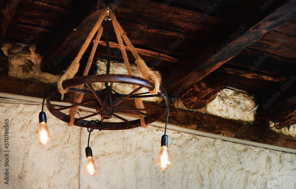 Handmade abstract chandelier under the wooden ceiling