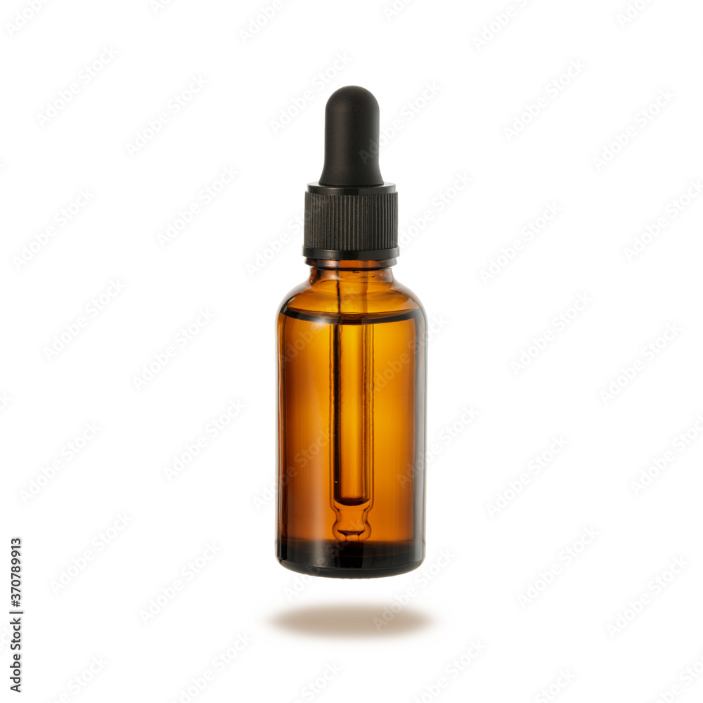 Dark brown glass bottle of face serum or essential oil