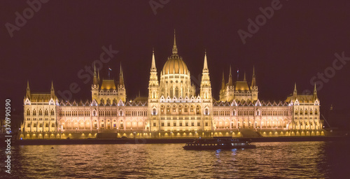 The Hungarian Parlament building at night in Budapestwith the Danube river