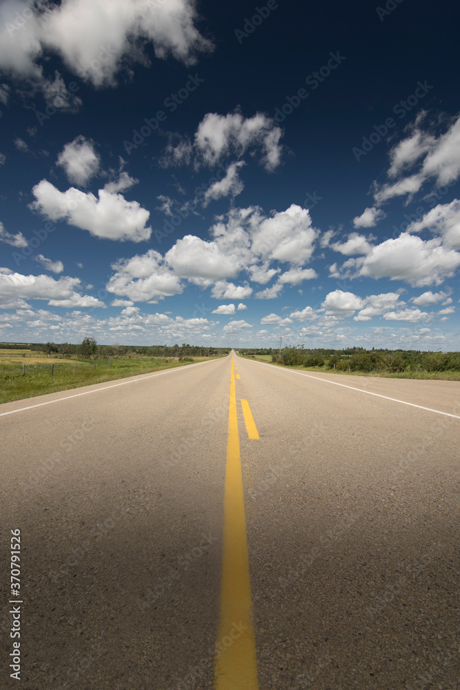 A scenic route along a prairie Highway in Northern Alberta under a deep blue sky. A scenic route along a prairie Highway in Northern Alberta under a deep blue sky.