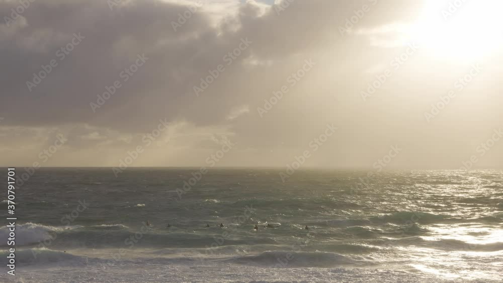 Surfers enjoying the large waves in a rough turbulent ocean at Cottesloe beach, Perth. Western Australia Tourism and lifestyle. Surfers enjoying the large waves in a rough turbulent ocean at Cottesloe beach, Perth. Western Australia Tourism and lifestyle.