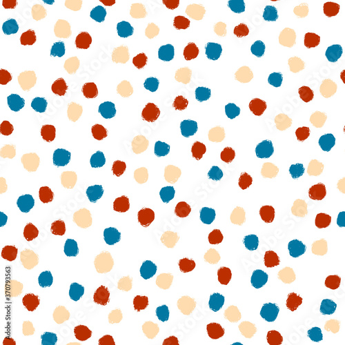 Colorful polka dot. Red, blue and caramel sprinkles on white background. Seamless pattern
