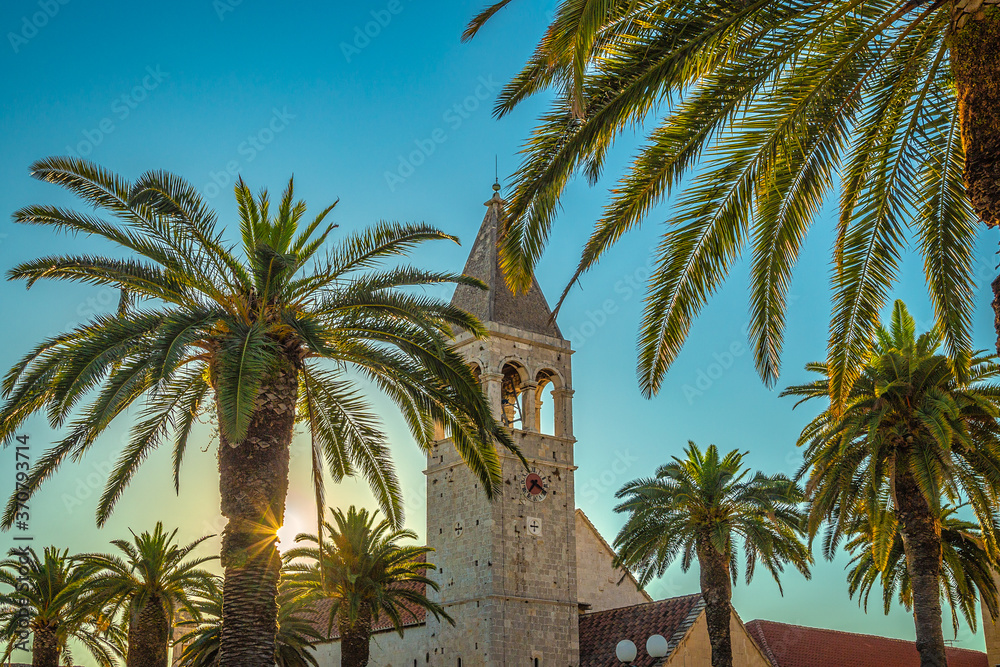 Historic architecture in Trogir with bell tower of Church of St. Dominic. An ancient town and harbour on the Adriatic coast, Croatia, Europe.