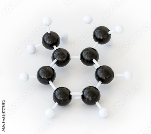Plastic ball-and-stick model of a 1,2 dimethylbenzene or ortho-xylene molecule (CH3)2C6H4, one of the xylene isomeres, shown with kekule structure on a white background.