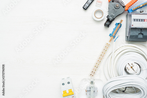 Electrical equipment and accessories on the white workbench background with copy space.