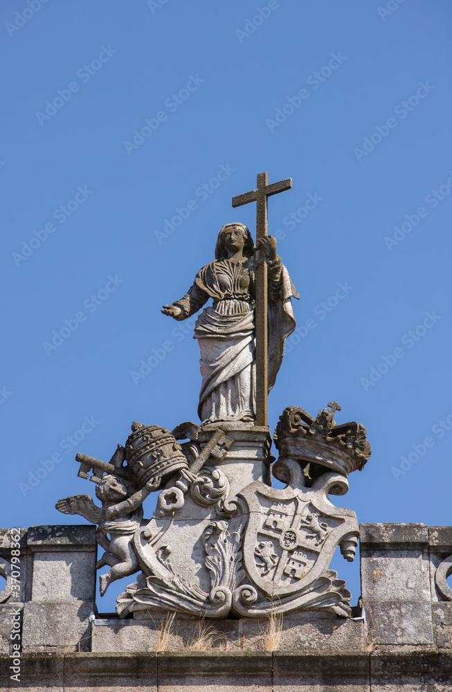 Religious stone statue on top of one building in Tui, Pontevedra, Spain