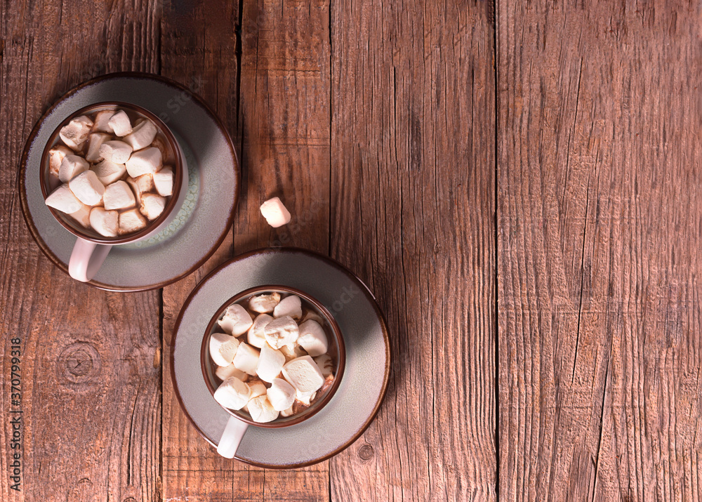 Hot chocolate with cinnamon and marshmallow on wooden background Hot chocolate with cinnamon and marshmallow on wooden background
