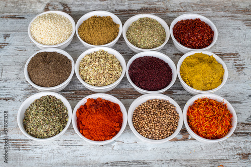 Colorful spices and herbs isolated on cooking background and design