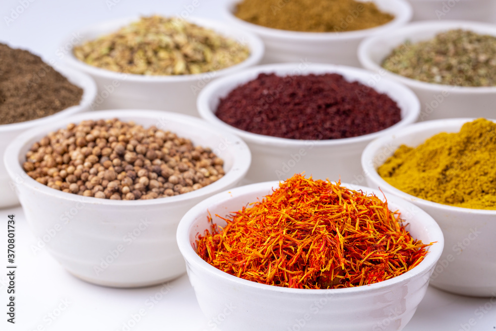 Colorful spices and herbs isolated on cooking background and design