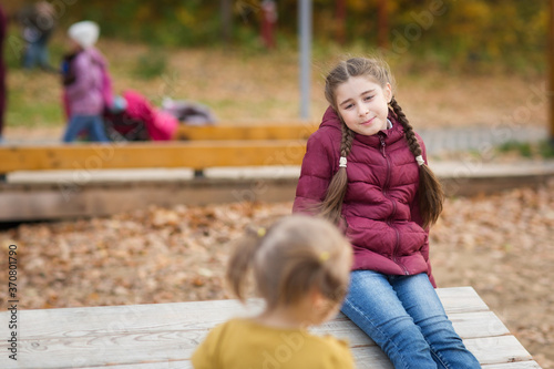 children walk in Park in autumn. season outdoors. natural emotions on girl's face