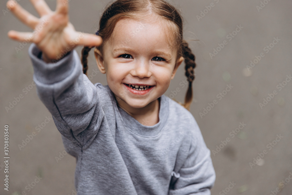 sincere children's laughter and fun, smiling girl playing and posing for a photo sincere children's laughter and fun, smiling girl playing and posing for a photo
