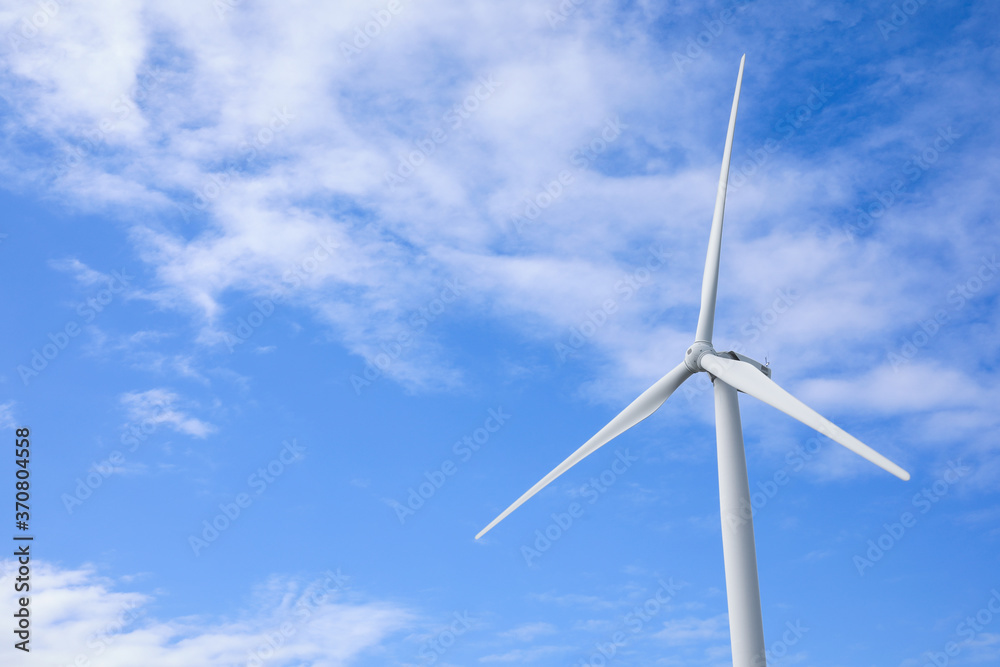 Wind turbine against beautiful blue sky. Alternative energy source Wind turbine against beautiful blue sky. Alternative energy source