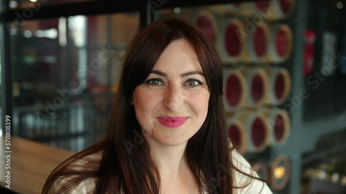 Wallpaper Mural Uses laptop, types. Communicates via video call. Finance success concept. Young female worker making talking on computer in the office. Portrait of girl looking directly into camera. Close up Torontodigital.ca