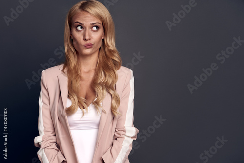Closeup photo of attractive business lady look side to empty space, creative person wear luxury office blazer suit white shirt isolated on grey color background