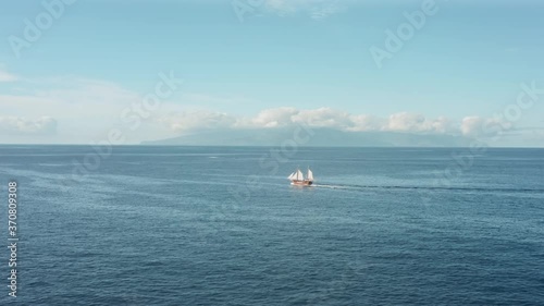 The romance of adventure, a lonely old pirate ship sailing in the open ocean.