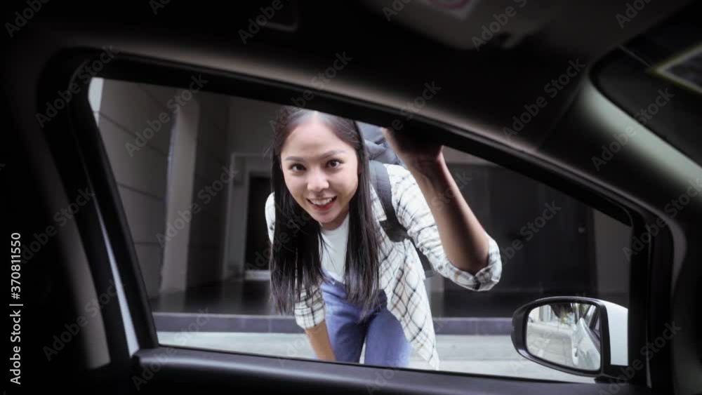 Young asian woman backpacker wearing aloha shirt traveling in urban city, She hitchhiking car and ask driver to go somewhere on the street safety from virus. Slow Motion Shot.