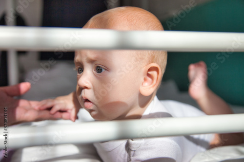 Toddler 6 months lies on his tummy and shows emotions