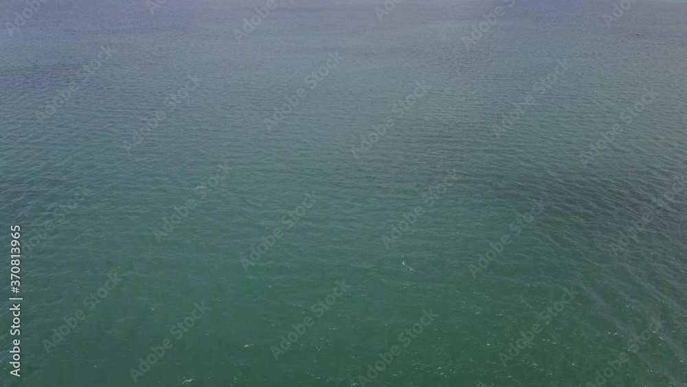 Aerial view following a fishing boat locals In the sea leaving the harbor at sunset Navigation in Phuket, Thailand.