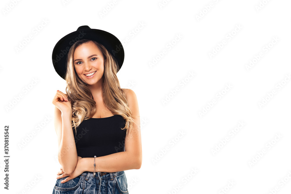 Young woman with beautiful smile happy and excited. Girl with blond hair in black clothes and hat at white background Young woman with beautiful smile happy and excited. Girl with blond hair in black clothes and hat at white background