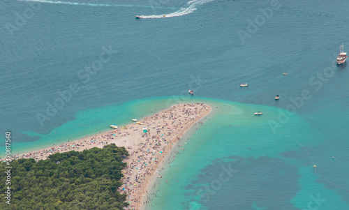 Zoomed in view from Vidova gora mountain of the famous golden Zlatni rat beach on the island of Brac. Famous for its shape, filled with tourists during the covid global pandemic in 2020