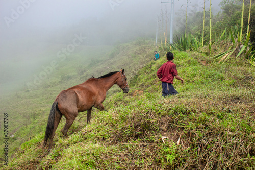 Yarumal, Antioquia / Colombia. June 6, 2019. Person with horse in mountain photo