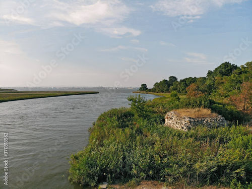 Picturesque coastline. The forest area descends to the coast of the bay along a gentle slope.
