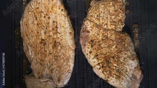 the juicy meat on the grill has just been laid out and it is being fried