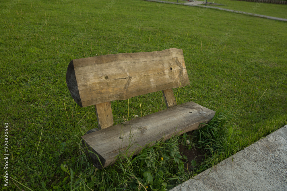 wooden bench on a green background photo from the side