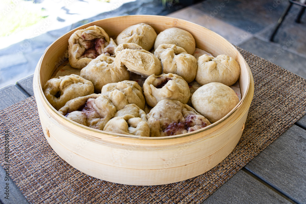 Japanese Nikuman dumplings in a bamboo steamer Japanese Nikuman dumplings in a bamboo steamer