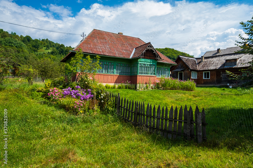 Traditional old wooden house and garden in Maramures, Romania Traditional old wooden house and garden in Maramures, Romania