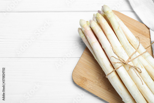 Fresh white asparagus on wooden table, top view. Space for text