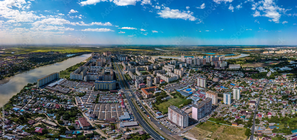 summer panorama of the large YUMR microdistrict in Krasnodar, which is built up with multi-storey buildings in 1990-2010. Bend of the Kuban River