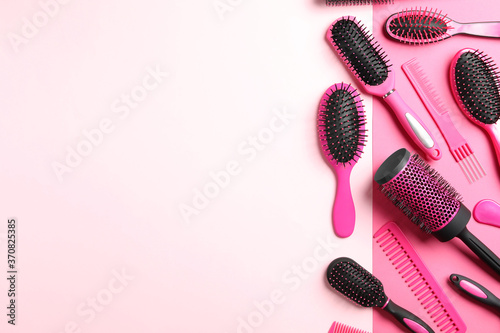 Different hair brushes and combs on color background, flat lay. Space for text