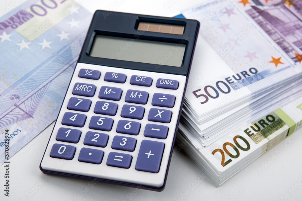 business still-life from a calculator and a bundle of banknotes 500 and 200 euros business still-life from a calculator and a bundle of banknotes 500 and 200 euros