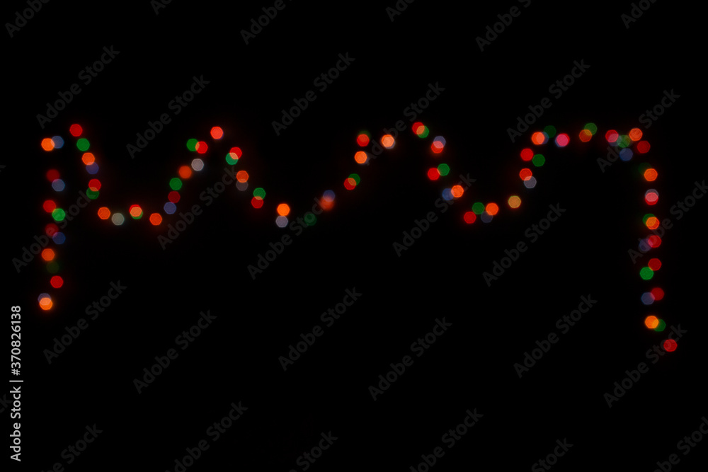 Multi-colored boke light bulbs in the dark. New Year's and Christmas Multi-colored boke light bulbs in the dark. New Year's and Christmas