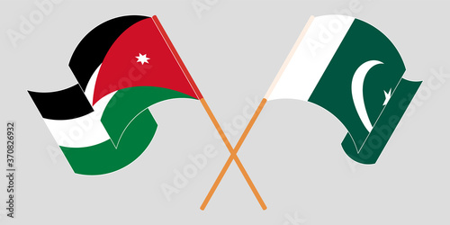 Crossed and waving flags of Jordan and Pakistan