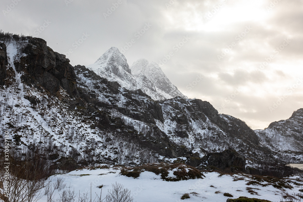 A cloudy winter mountain landscape in Lofoten. 