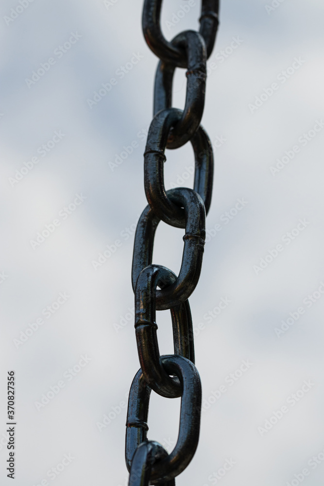 metal chain on blue sky background, close up metal chain on blue sky background, close up