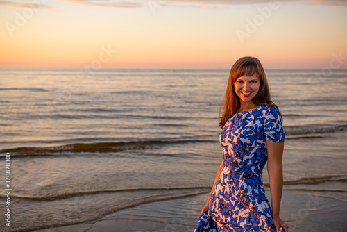 Beautiful young woman relaxing at sunset