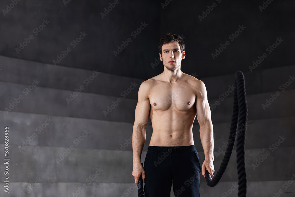 Handsome strong athletic man on sport gym club.