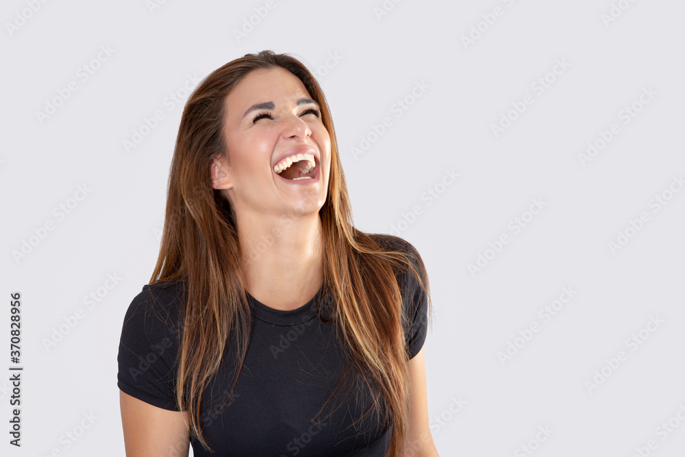 Beautiful young woman laughing on white background Beautiful young woman laughing on white background